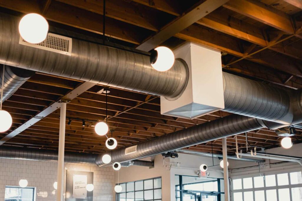 hvac ducts and vents hanging from the ceiling of a commercial building