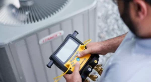 technician using tools to perform a diagnostics on hvac unit