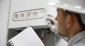 plumber holding a clipboard and diagnosing a water heater